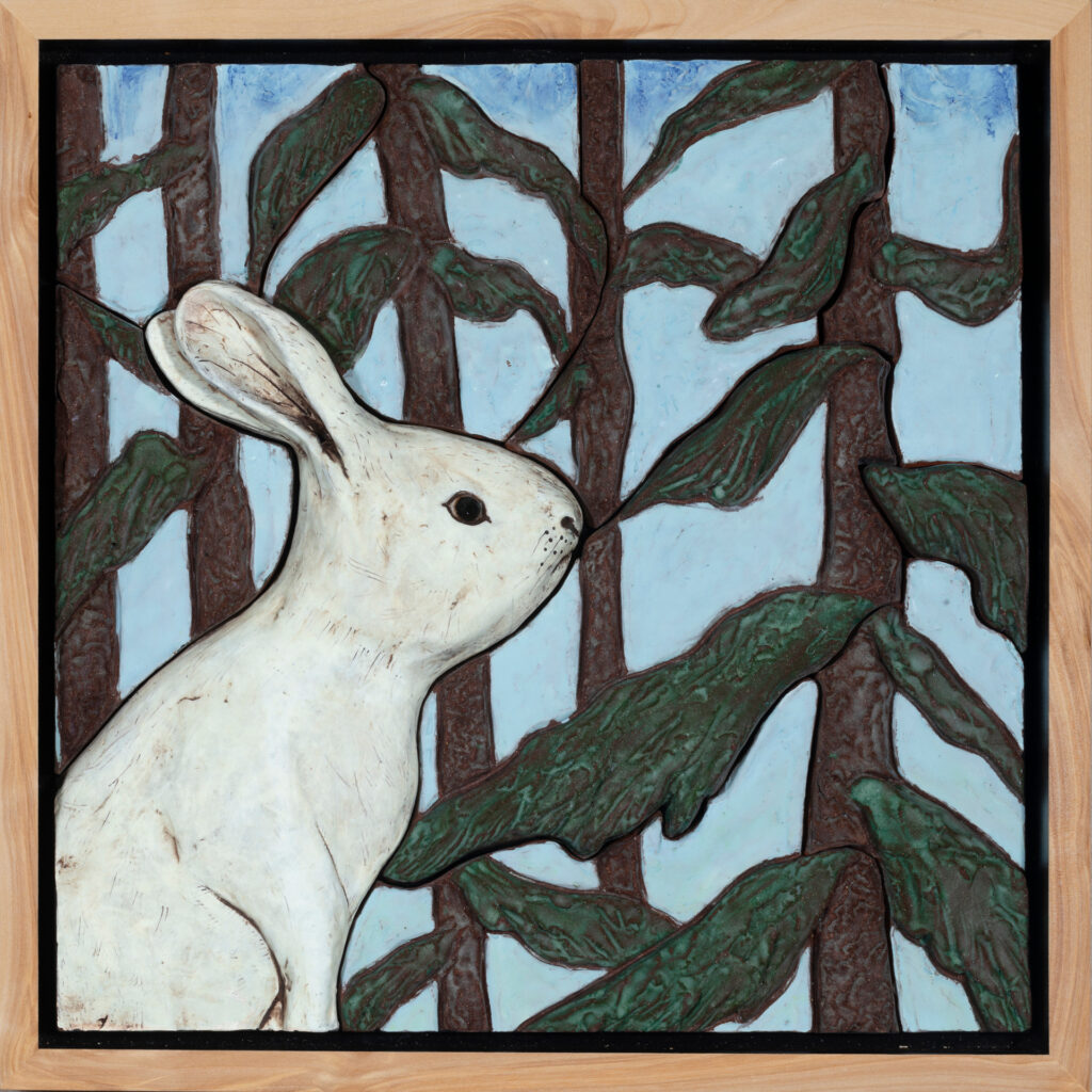 clay snowshoe hare in forest tiles in a frame